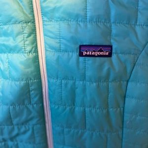 Woman’s light blue Patagonia puffy coat